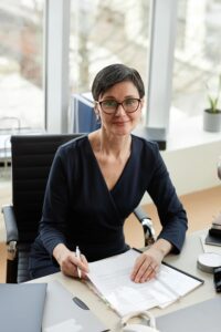 Woman signing documents at a desk