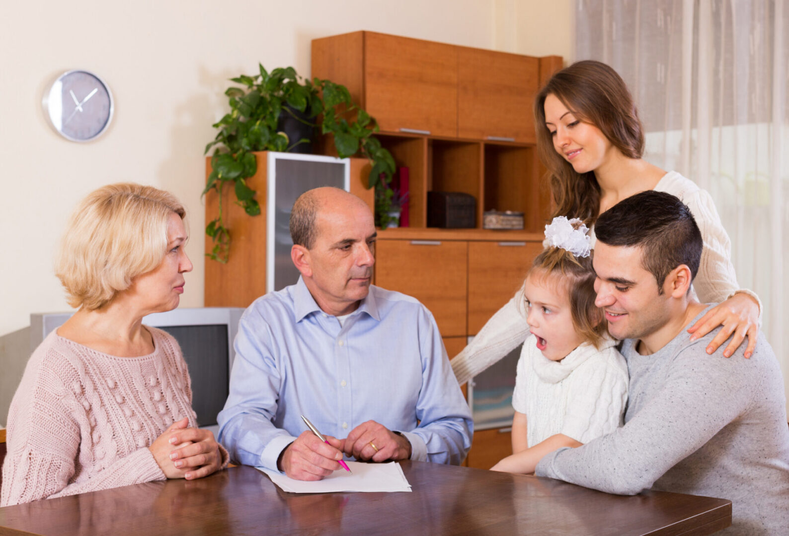 Family discussing around a table at home.