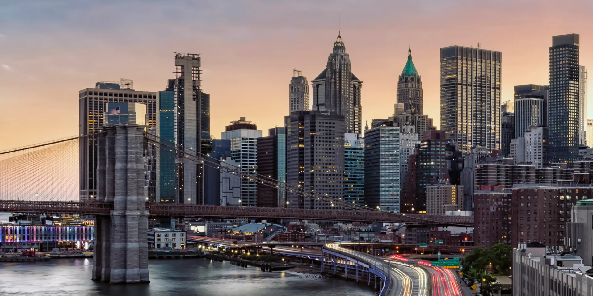 Vibrant cityscape featuring illuminated bridge and buildings